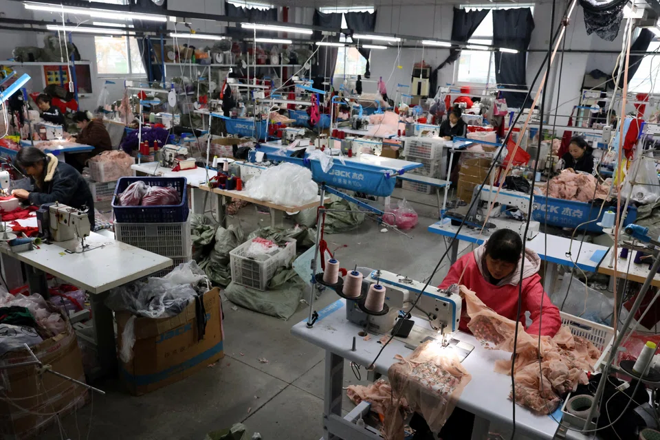 Employees work on sewing machines at the Midnight Charm Garment lingerie factory in Guanyun county of Lianyungang, Jiangsu province, China, Nov 25, 2024.