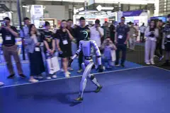 A robot controlled by a remote by Unitree Robotics walks during the Mobile World Congress (MWC 2026) at the Shanghai New International Expo Centre in Shanghai on Jun 18.
