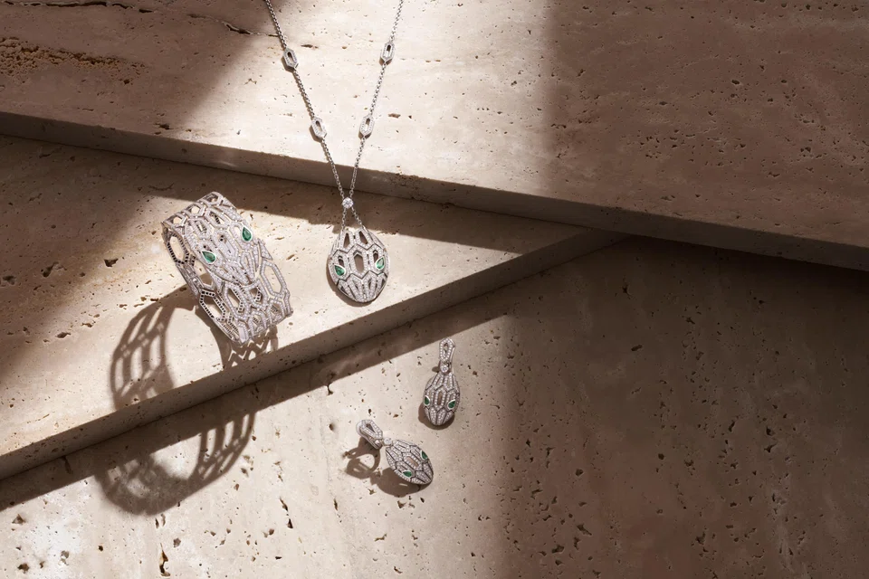 Left to right: Serpenti bangle, necklace and earrings in white gold with pavè diamonds and emeralds 
