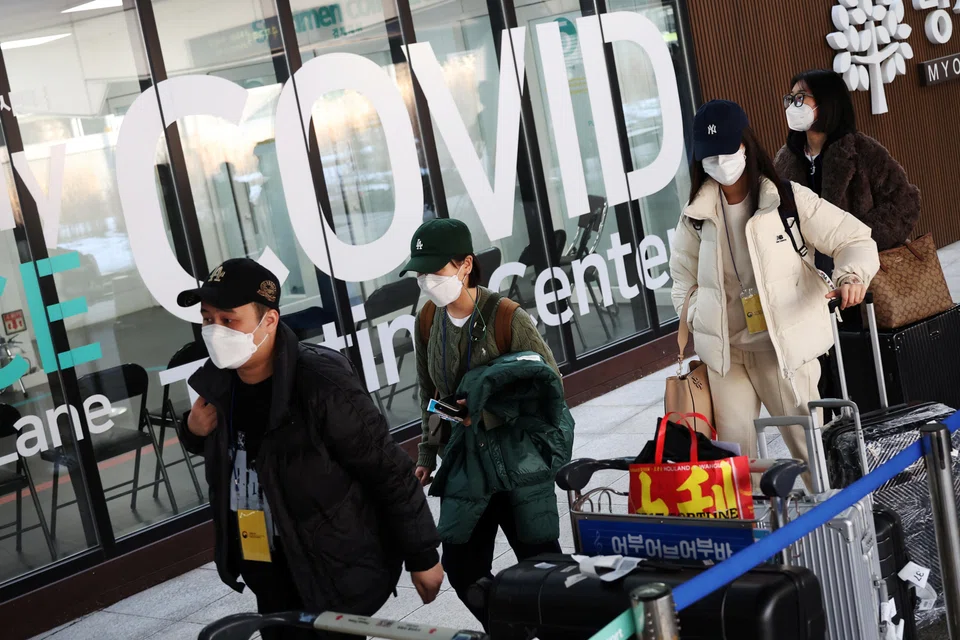 Chinese tourists walk into a Covid-19 testing centre upon their arrival at the Incheon International Airport in Incheon, South Korea, Jan 4, 2023.  South Korea said on Friday it would begin issuing short-term visas to travellers from China again.  