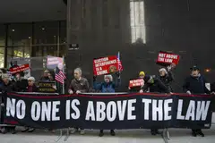 Protesters hold a banner reading “no one is above the law” outside former President Donald Trump's criminal trial at Manhattan Criminal Court in Manhattan, April 22, 2024. 