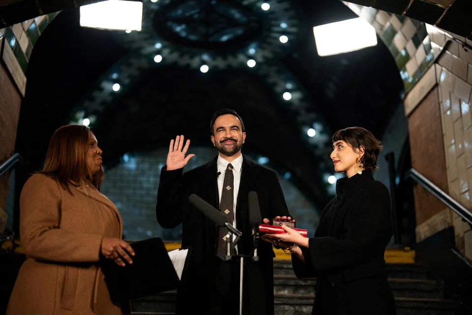 Zohran Mamdani is sworn in as mayor of New York City shortly after midnight on Jan 1.  He is flanked by his wife, Rama Duwaji, (right) and New York Attorney-General Letitia James.