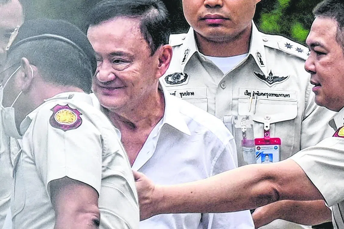 Thailand's former Prime Minister Thaksin Shinawatra (centre) is escorted into a police van outside the Supreme Court in Bangkok after he was sentenced to a year in prison, Sep 9, 2025.