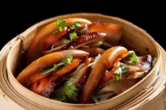 Deep fried mantou buns are stuffed with fatty iberico pork and pickles.