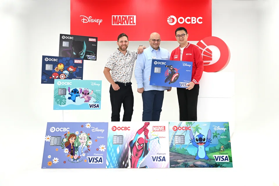 From left: Walt Disney's South Asia VP and GM for consumer products Alex Baillie, Walt Disney's VP and GM for Disney Entertainment SEA Vineet Puri, and OCBC's head of global consumer financial services Sunny Quek, with the Disney designs that will be featured on select OCBC cards by mid-2025.