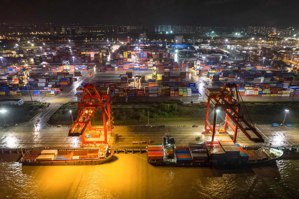 Cargo ships berthing at China's Nanjing port. US-China trade surged to a record in 2022, in defiance of all the talk and threats about decoupling.
