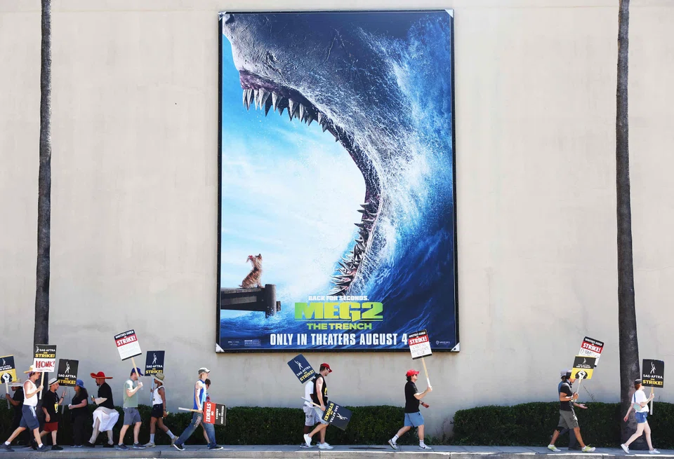 Striking Writers Guild of America members picket with striking SAG-AFTRA members outside Warner Bros Studio on Aug 16, 2023 in Burbank, California. 