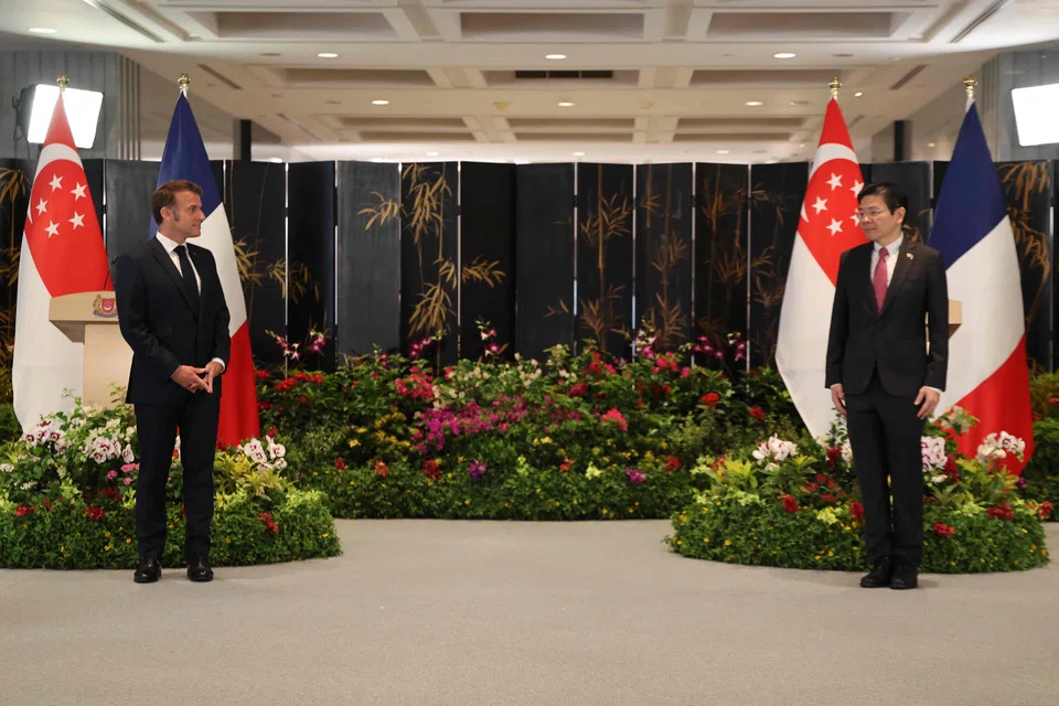 French President Emmanuel Macron (left) with Singapore Prime Minister Lawrence Wong.