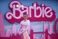 Margot Robbie poses on the pink carpet upon arrival for the European premiere of "Barbie" in central London on July 12, 2023. Hollywood's pink wave has yet to crest as Warner Bros.' "Barbie" dominated for a third straight weekend in North American theatres, pushing the film's global haul past US$1 billion.