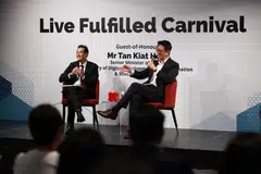 Speaking at a DBS carnival for its employees, Senior Minister of State for Digital Development and Information Tan Kiat How (left) said AI will not steal jobs away from human workers because there are still tasks it cannot perform. 