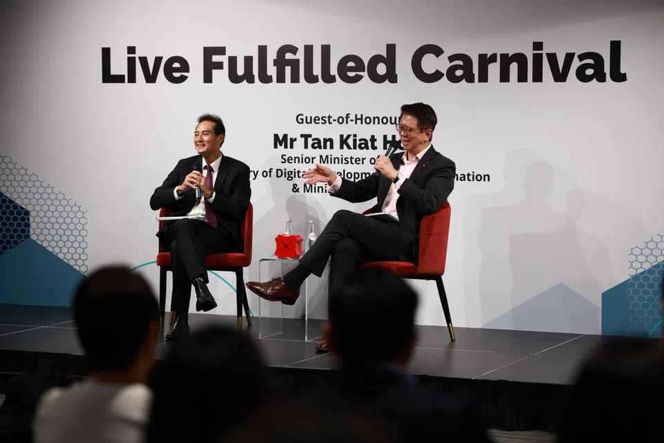 Speaking at a DBS carnival for its employees, Senior Minister of State for Digital Development and Information Tan Kiat How (left) said AI will not steal jobs away from human workers because there are still tasks it cannot perform. 