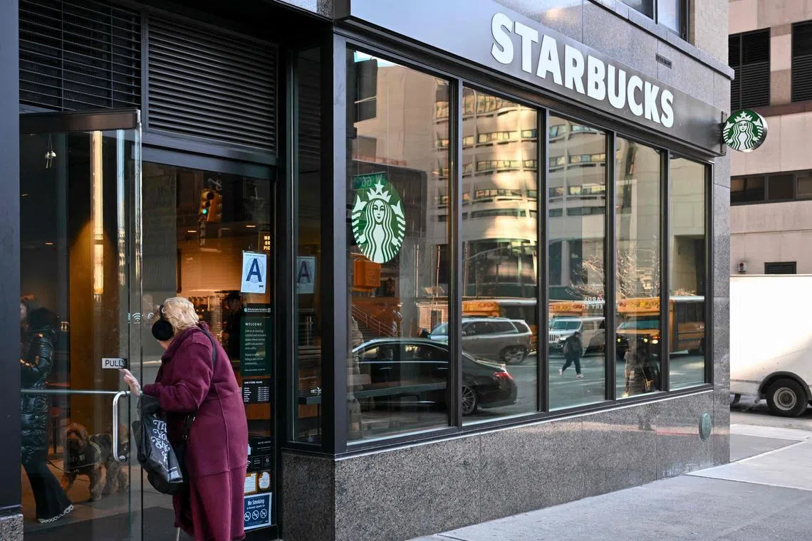 A person enters a Starbucks in New York City on January 14, 2025. Wall Street stocks mostly fell early January 13, 2025 as Treasury bond yields lingered at a high level while markets looked ahead to earnings and economic data releases. (Photo by ANGELA WEISS / AFP)
