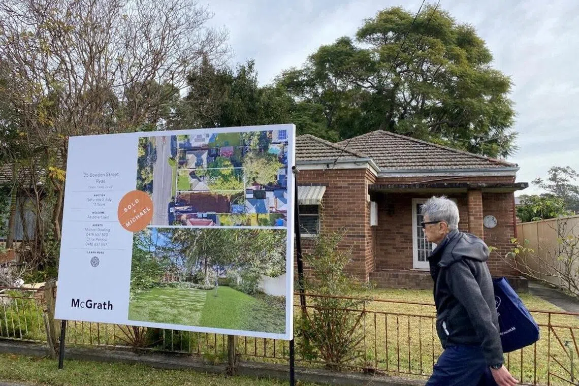 FILE PHOTO: A man walks past a derelict home, which sold for A$1.6 million, in Sydney's northwest in Australia June 23, 2021. REUTERS/Swati Pandey/File Photo