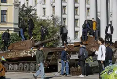 Youths climb on destroyed Russian military machinery in Kyiv, Ukraine. The war seems to be stalemated, but Putin has turned it into a war of attrition.