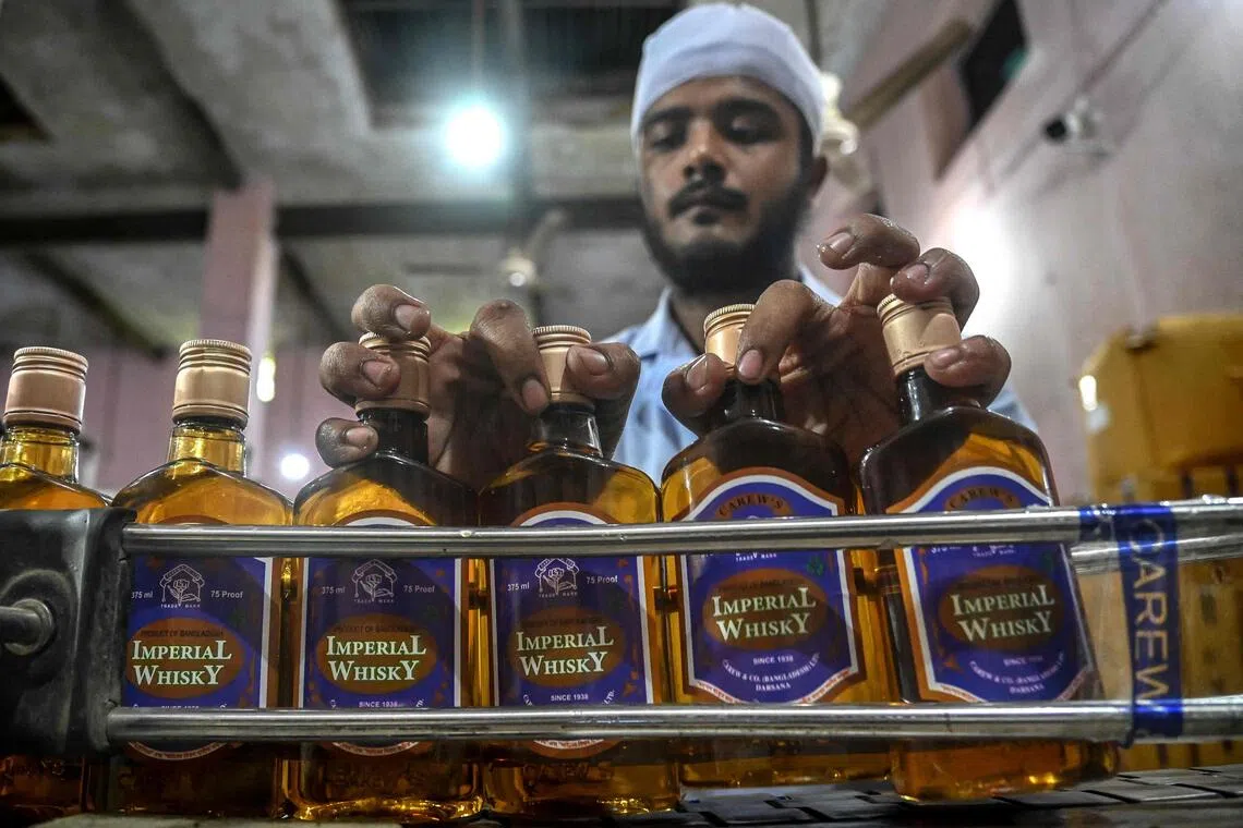 An employee at the Carew and Co distillery in Darsana, in southwestern Bangladesh. Carew’s popular brands range from the golden-hued “Imperial Whisky” to “Tsarina Vodka”, distilled from sugarcane with flavourings imported from the Netherlands.