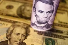 THE US dollar trimmed early losses and held near a 20-year peak on Tuesday (Jun 14) while its rivals from the Aussie to the euro struggled as traders braced for aggressive interest rate hikes from the Federal Reserve this week.