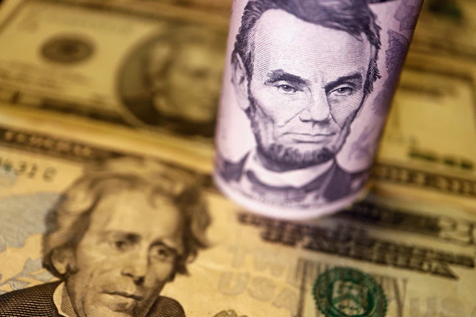 THE US dollar trimmed early losses and held near a 20-year peak on Tuesday (Jun 14) while its rivals from the Aussie to the euro struggled as traders braced for aggressive interest rate hikes from the Federal Reserve this week.