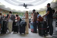 People wait for their flight after a global outage at LaGuardia Airport in the Queens borough of New York on Jul 19, 2024. 