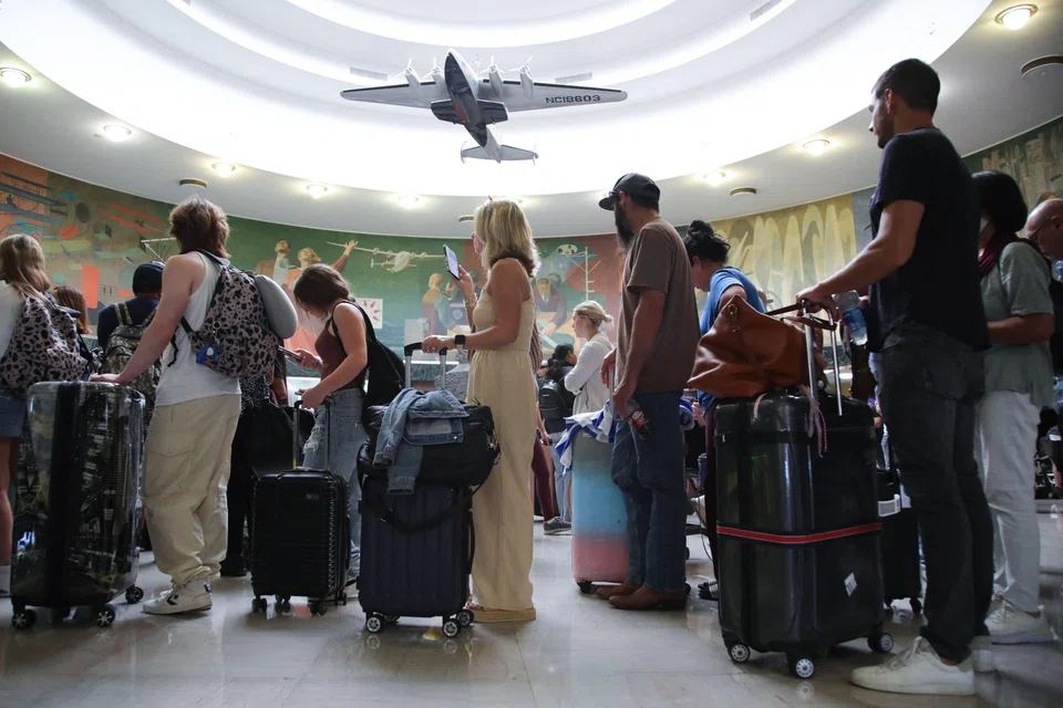 People wait for their flight after a global outage at LaGuardia Airport in the Queens borough of New York on Jul 19, 2024. 