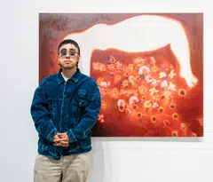 Kevin Poon with a painting by Diane Chappalley at Woaw Gallery.