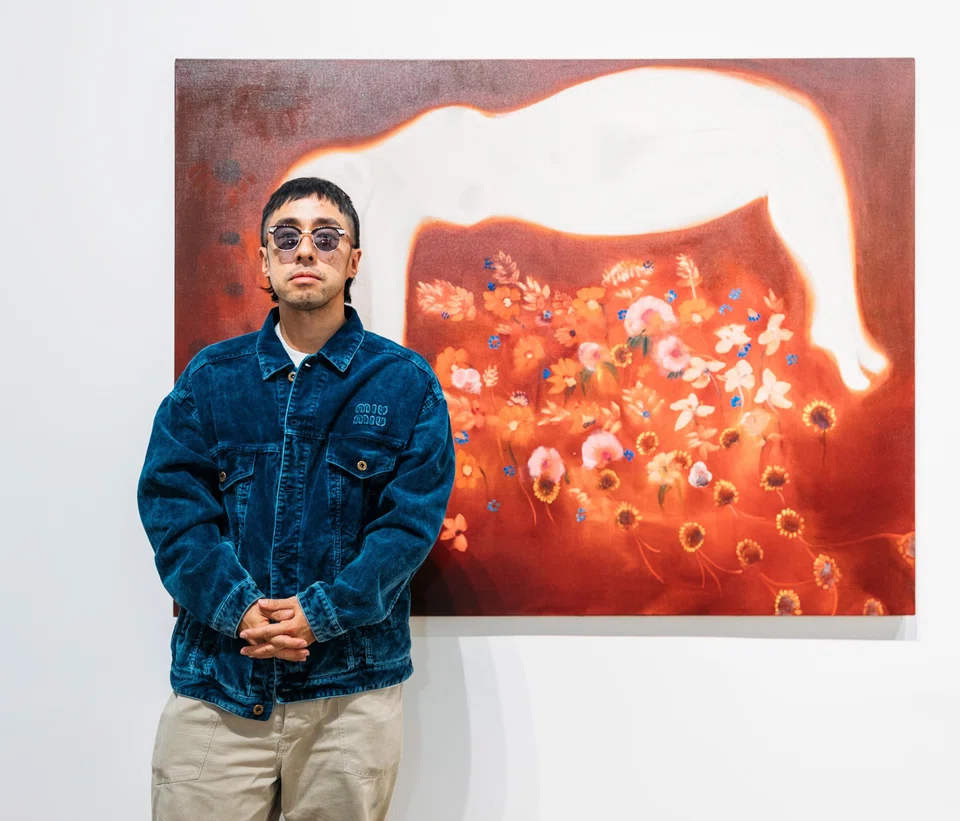 Kevin Poon with a painting by Diane Chappalley at Woaw Gallery.