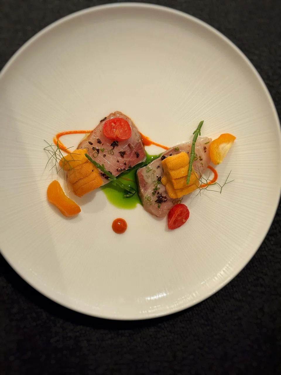 Yellowtail sashimi and uni need no embellishment beyond a sweet-sour vinaigrette and herb oil.