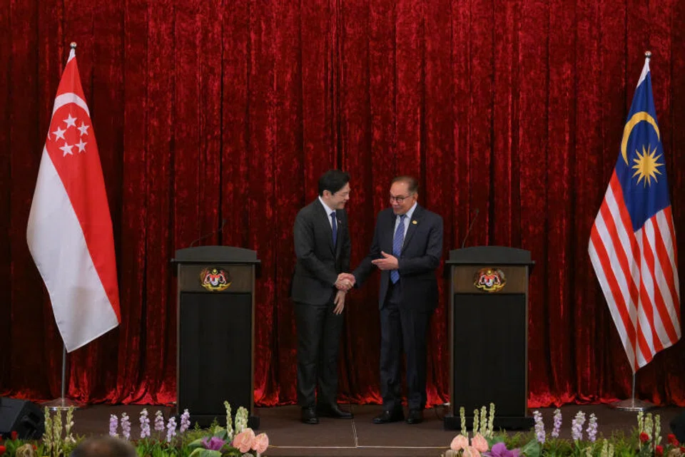 Singapore's Prime Minister Lawrence Wong (left) and Malaysia's Prime Minister Anwar Ibrahim shake hands after holding a joint press conference in Malaysia on Jun 12, 2024.