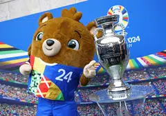Euro 2024 mascot Albart posing with the European Championship trophy in Berlin. UEFA expects the tournament to generate revenues of about 2.4 billion euros (S$3.49 billion) for itself, its subsidiaries and the German Football Association.