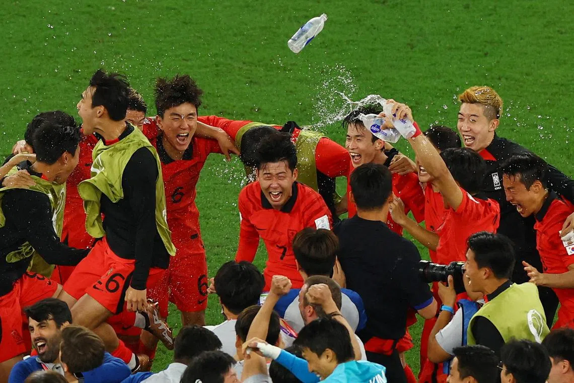 South Korea's Son Heung-min (centre) and his teammates celebrate wildly after they defeated Portugal 2-1 to qualify for the Round of 16. South Korea will play Brazil on Dec 6 for a place in the quarter-finals