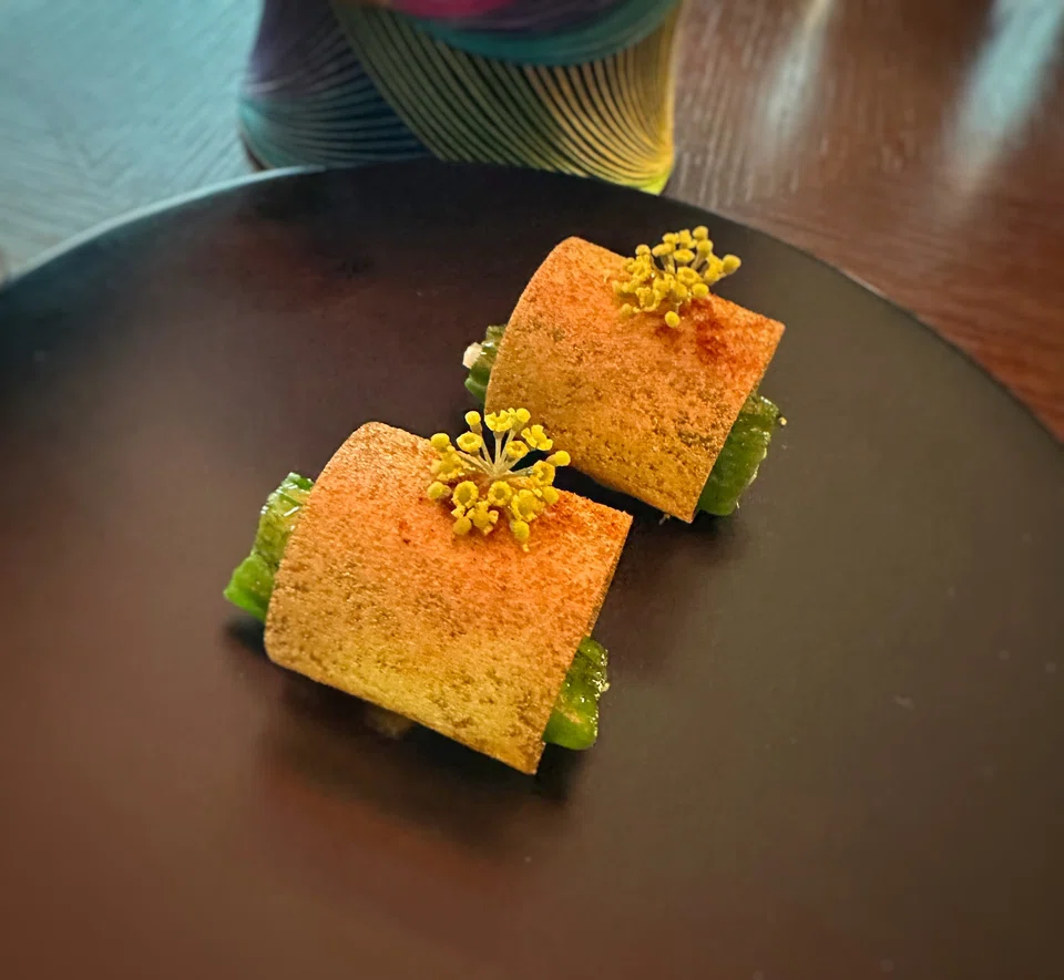 Chile is a curl of potato chip and shishito peppers.