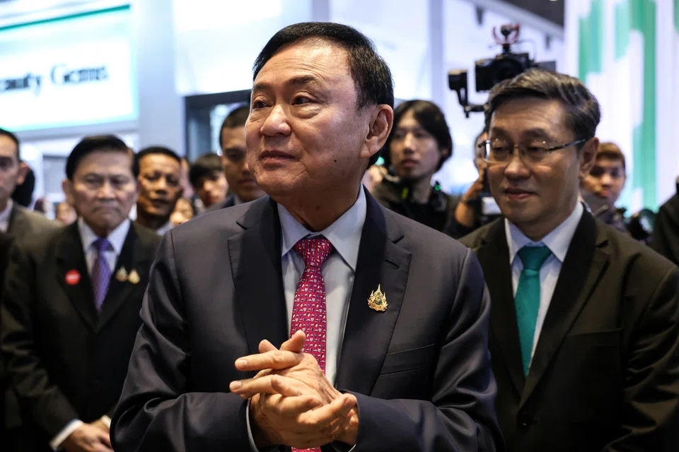 Thaksin Shinawatra (centre) has his own legal troubles, including a decade-old royal defamation case that is due to be ruled on next month. 