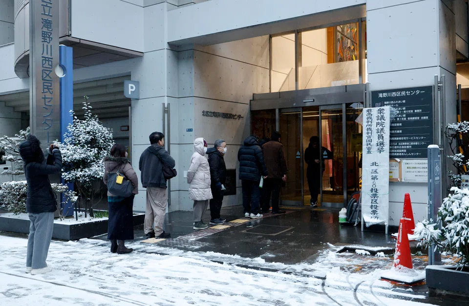 Voters line up at a polling station to vote for the Lower House election in Tokyo, Japan on Feb 8.