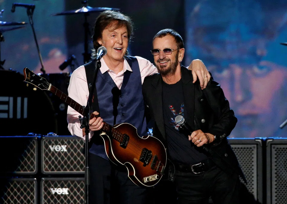 The song also features parts recorded by surviving members Paul McCartney (left) and Ringo Starr (right) as well as the late George Harrison.