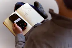 New York Times columnist Brian Chen holds a smartphone running ChatGPT4o as it tries to solve a geometry problem, in San Francisco, US, May 28, 2024. 