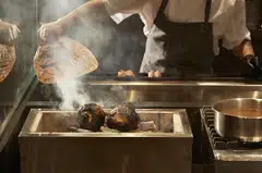 Hanazen's kitchen takes up the bulk of the space, with two facing charcoal grills.