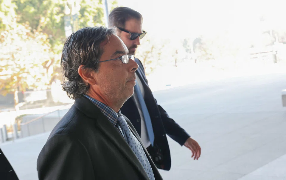 Former medical doctor Mark Chavez (front) arrive for his sentencing at the United States District Court in Los Angeles, California, Dec 16, 2025. 