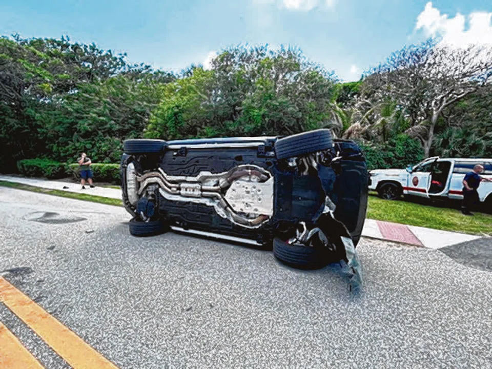 Tiger Woods' Land Rover rolled over on a two-lane road near his Jupiter Island home.