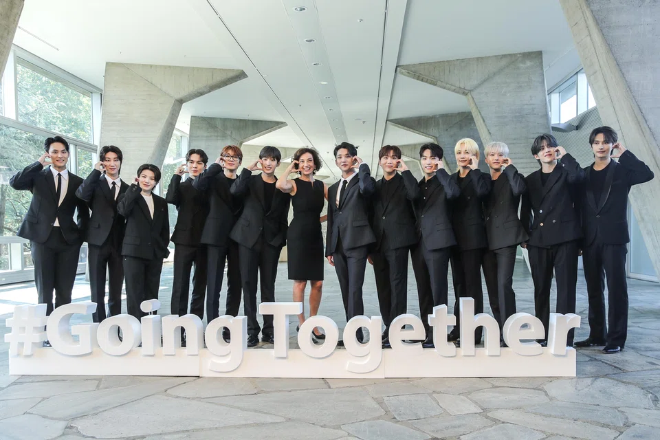 Unesco Director-General Audrey Azoulay (C) poses with members of the South Korean K-Pop group Seventeen during a photocall as part of their appointment ceremony as Unesco's goodwill Ambassador for Youth in Paris.