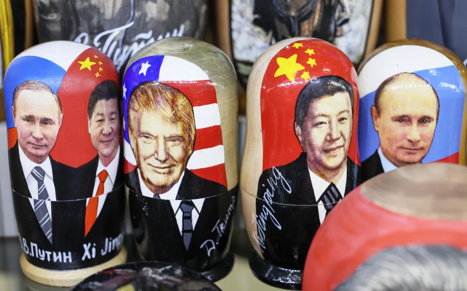 Traditional Russian wooden dolls depicting Russian President Vladimir Putin, China President Xi Jinping and US President Donald Trump displayed at a souvenir shop in Moscow, Russia, Feb 13, 2025. Trump - who has cast himself in his second term as a global peacemaker - said he would consider a summit with Putin and Xi “when things calm down.”