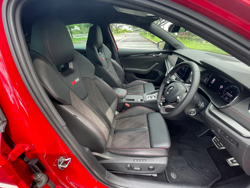 The front seats may look racy, but they double as massage chairs, lightly kneading your spine at the touch of a button.
