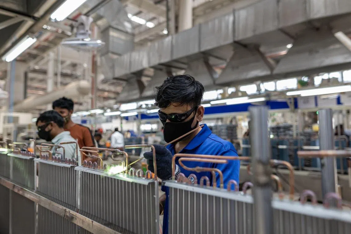 A welder at Haier's air conditioner factory in Greater Noida, India, in May 2023. Demand for air conditioners is surging in the country. Haier's organisational model allows it to stay close to users and build an innovative company. 