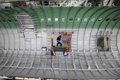 Airbus pushed back its goal to produce 75 of its A320 single-aisle jets per month by one-year to 2027.