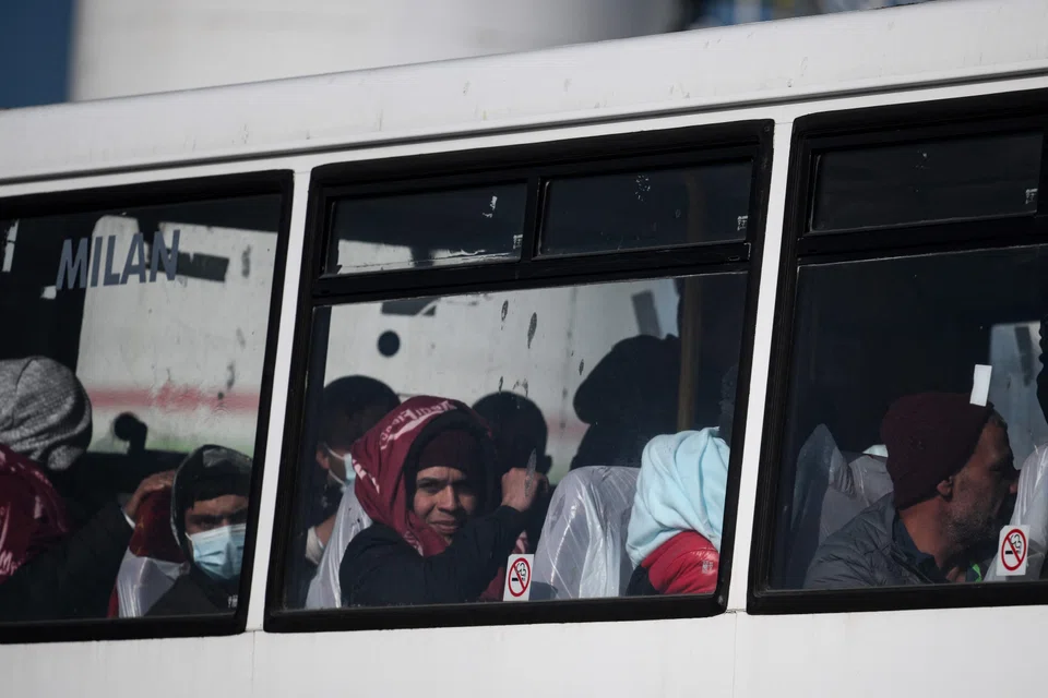 Migrants, picked up at sea while attempting to cross the English Channel from France, being taken by bus to a processing centre after disembarking from a UK Border Force boat in Dover on the south-east coast of England.  