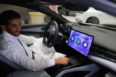 A man inspects an electric car at a showroom in Riyadh, Saudi Arabia, June 8, 2024. Although the EV market in the world's largest oil exporter remains small compared with the United States and China, it tripled last year to nearly 800 cars, according to Saudi business news outlet Al-Iqtisadiyah. 