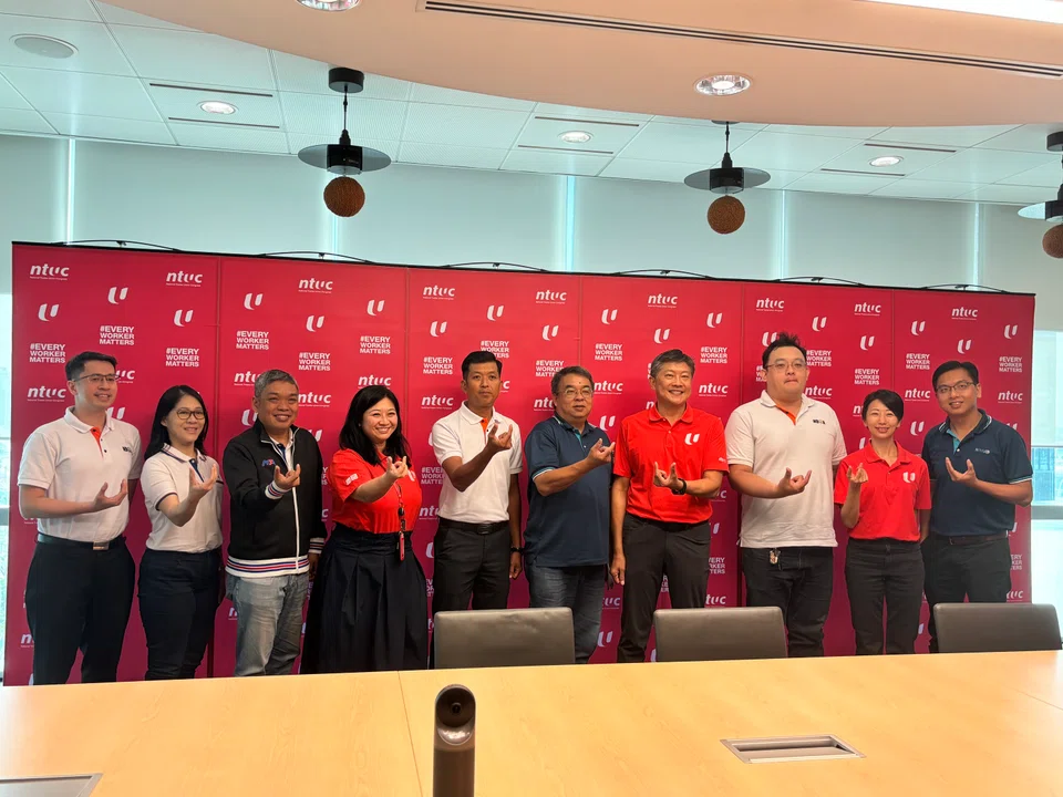 NTUC secretary-general Ng Chee Meng (seventh from left), assistant secretary-general Yeo Wan Ling (fourth from left) and director of the Union of Freelancers and Self-Employed Persons Jean See (second from right) with platform work association representatives.