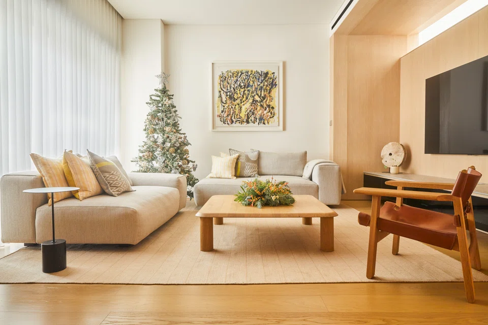 A Christmas tree anchors the living room, which is designed to feel like a hotel lobby.