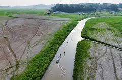 Fishermen dragging a boat on the dry bed of Lake Aleixo during what the national disaster monitoring agency Cemaden has already called Brazil's worst drought since at least the 1950s, near Manaus, Amazonas State, Brazil, Oct 29, 2024. 