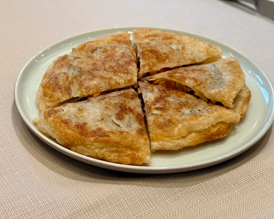 Flaky pancake stuffed with red bean paste and almonds.