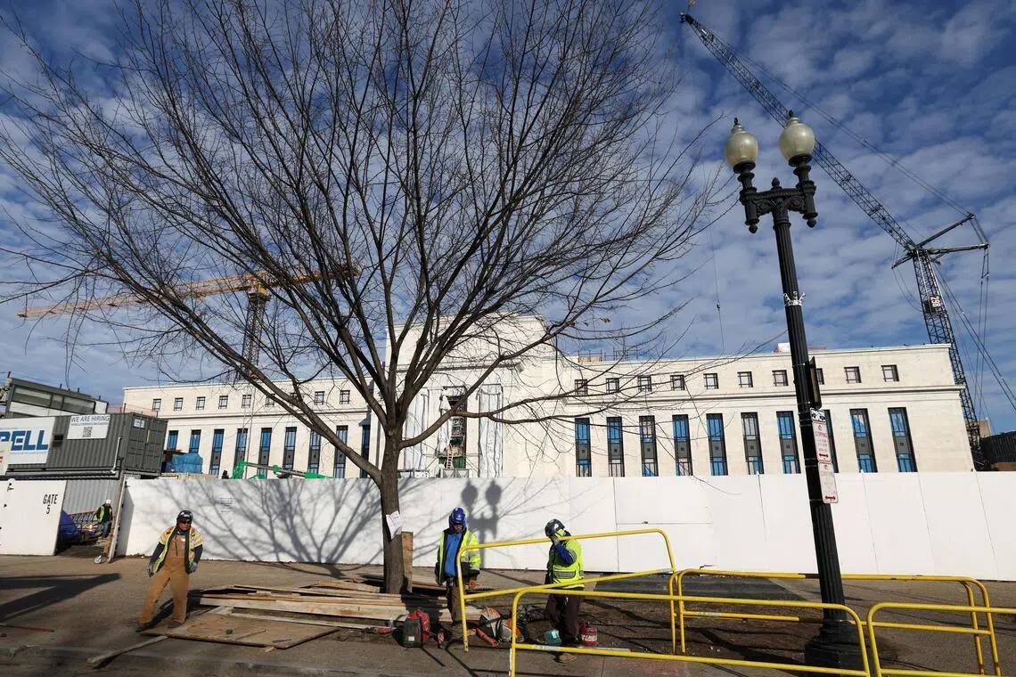 Cranes looming over the construction site of the US Federal Reserve headquarters. The central bank's policy direction and commentary in early 2026 could influence risk appetite and volatility.