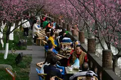 People sitting along a river at a park in Chengdu, Sichuan’s vibrant 3,000 years-young capital.